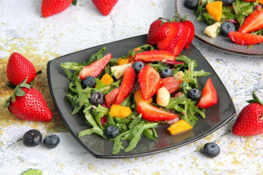 Fruit salad dessert with mango and strawberries