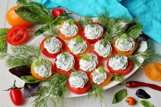 Appetizer of red and yellow tomatoes with cheese and garlic