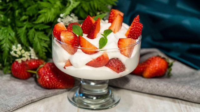 Strawberries with cream, dessert in a creamer