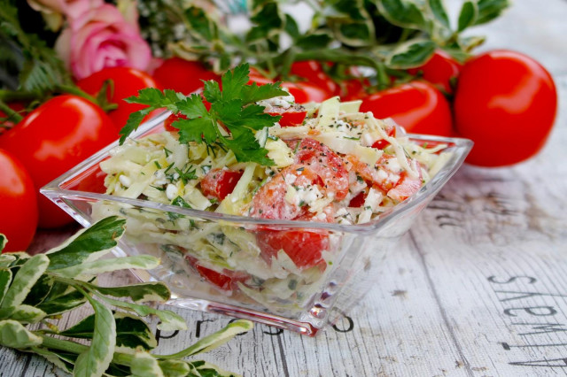 Salad of young cabbage with tomatoes and cottage cheese.