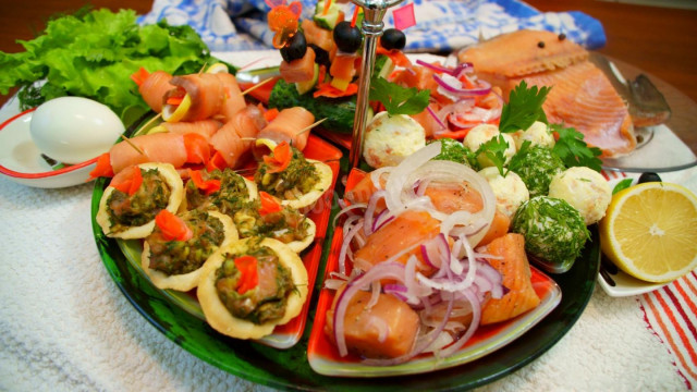 A plate of snacks with red fish
