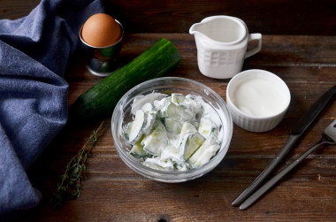 Salad from fresh cucumbers in sour cream