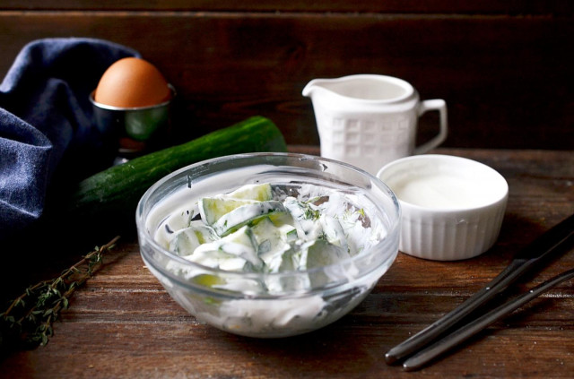 Salad from fresh cucumbers in sour cream