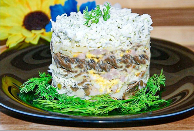 Bride salad with mushrooms, mayonnaise and smoked chicken