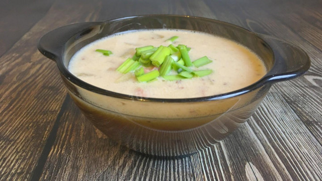 Potato soup with ham, soft cheese in chicken broth