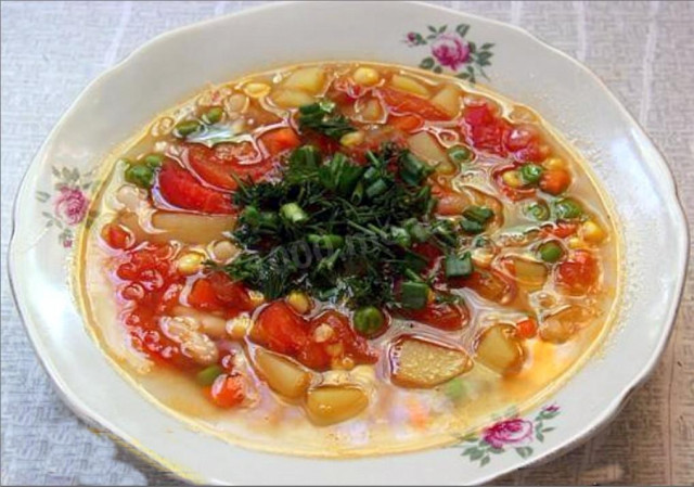Minestrone soup with vegetables, herbs and butter