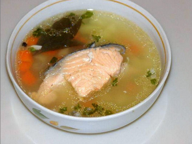 Salmon soup with potatoes, carrots, onions and herbs