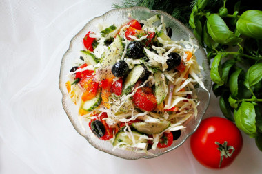 Salad with olives and tomatoes with young cabbage