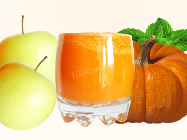 Pumpkin juice for winter with apples in a juicer