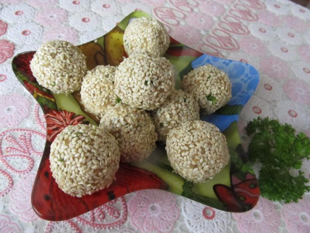 Salad balls with cod liver in sesame seeds