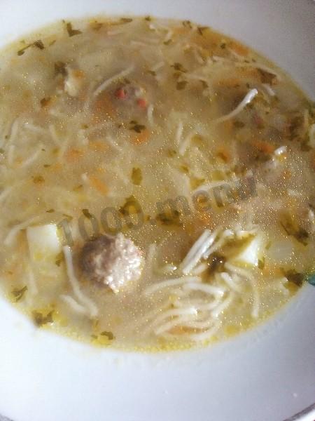 Soup with meatballs and noodles and potatoes