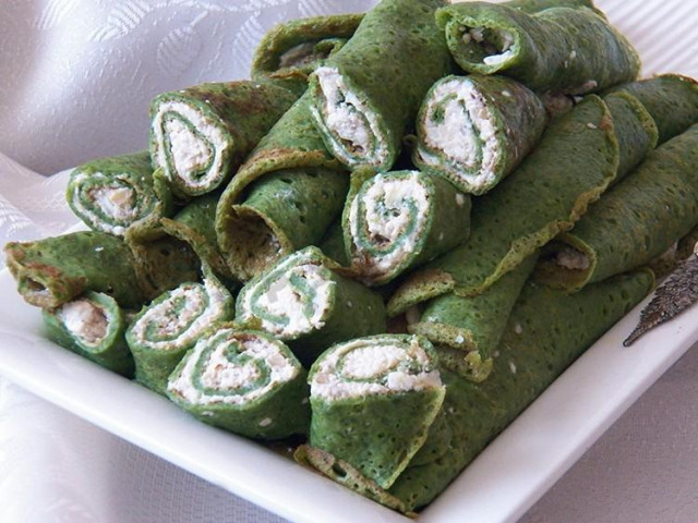 Pancakes with spinach with cheese filling, garlic and nuts
