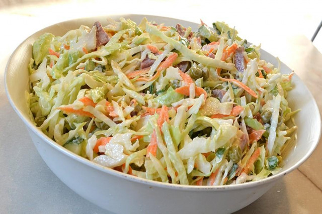 Young cabbage salad with sausage and green onions