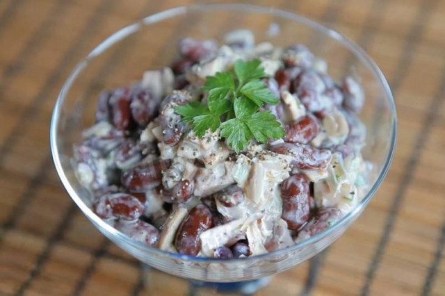 Salad with chicken, pickled mushrooms, beans and mayonnaise