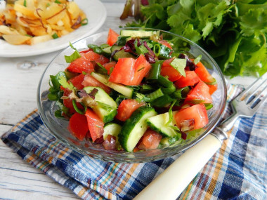 Salad with cucumbers and tomatoes with butter