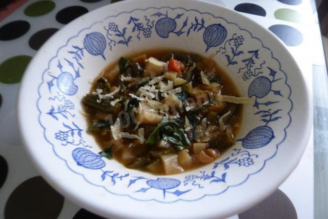 Tomato soup with grated cheese and basil