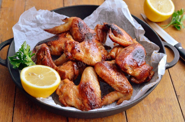 Fried chicken wings in a frying pan
