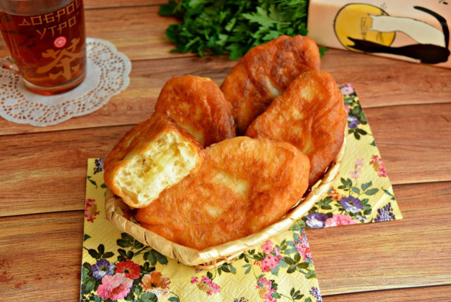 Fried potato pies with yeast in a frying pan