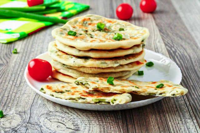 Tortillas with green onions in a pan