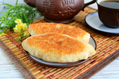 Fried cabbage pies in a frying pan