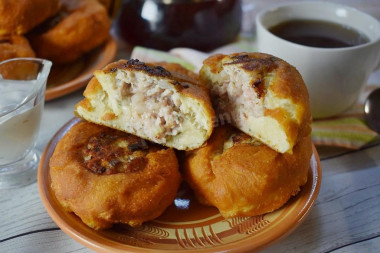 Fried white bread in a pan with meat