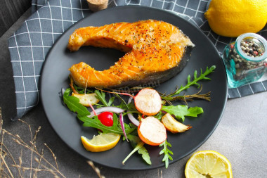 Juicy pink salmon fried in a pan