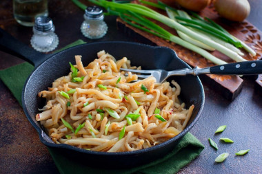 Squid fried in soy sauce with garlic in a pan