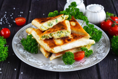 Pita bread with cheese fried in a pan