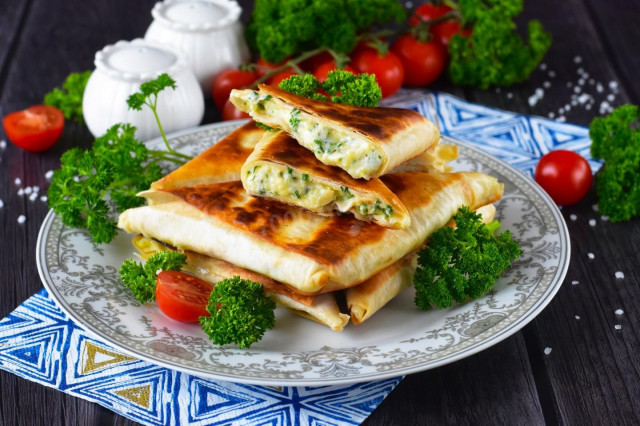 Pita bread with cheese fried in a pan