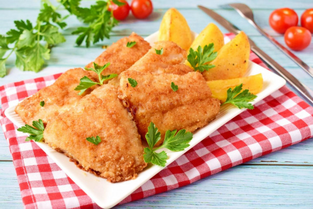 Fried pike perch in a frying pan