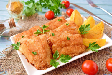 Fried pike perch in a frying pan