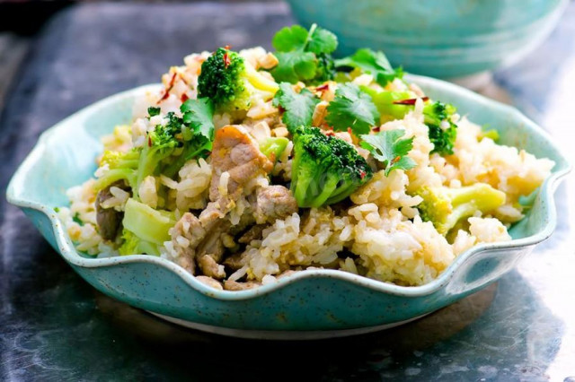 Fried rice with vegetables and soy sauce in a wok pan