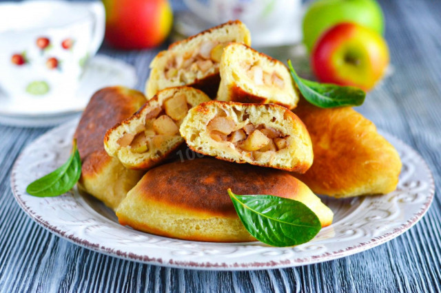 Pies with apples fried in a frying pan