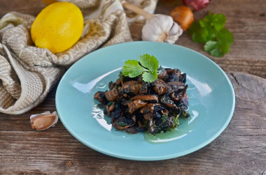 Fried mushrooms with garlic in a frying pan