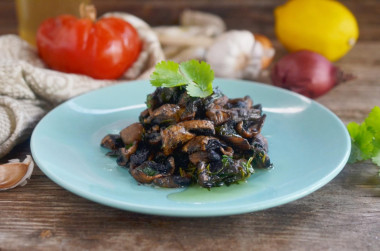 Fried mushrooms with garlic in a frying pan