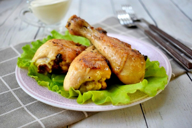 Chicken legs fried with dry spices in a frying pan