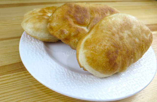 Fried pies with potatoes from yeast dough in a frying pan