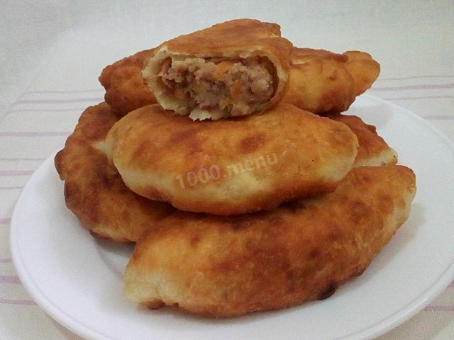 Bean pies fried from yeast dough in a frying pan