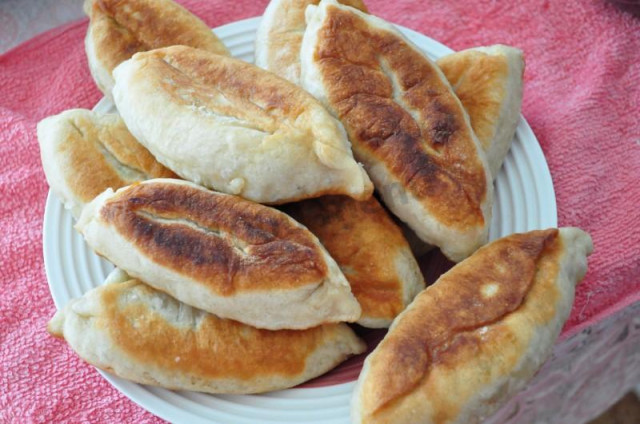 Fried pies with green onions and egg on water