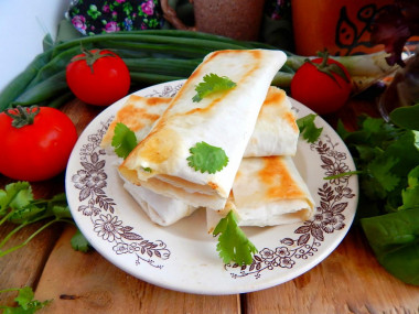 Pita bread in a frying pan with cheese