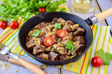 Liver with onions in a frying pan