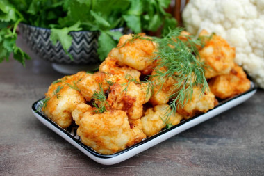 Cauliflower in batter in a frying pan