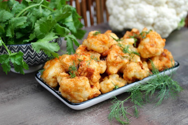 Cauliflower in batter in a frying pan