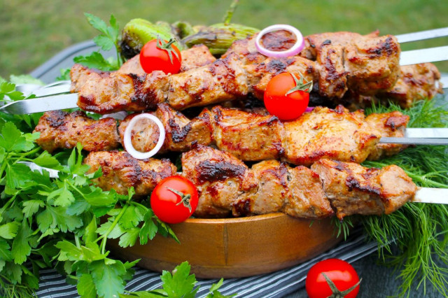 Shish kebab in marinade with mayonnaise and pork onion