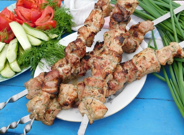 Soft and juicy pork kebab with vinegar and with a bow