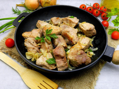 Juicy pork in a frying pan