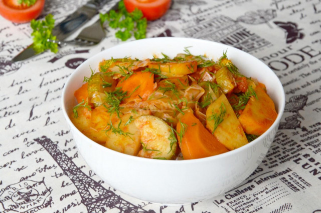 Vegetable stew of zucchini potatoes and cabbage in a frying pan