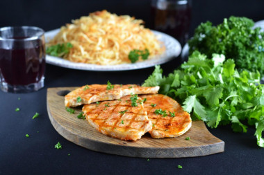 Juicy proper pork steak in a frying pan