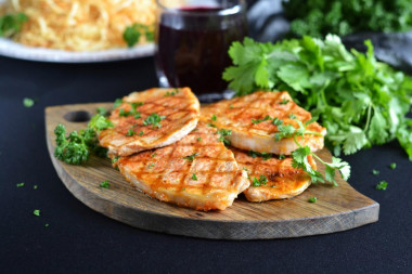 Juicy proper pork steak in a frying pan