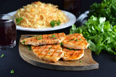 Juicy proper pork steak in a frying pan